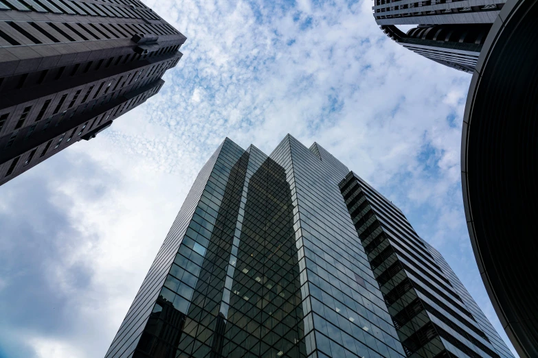 looking up at two tall buildings in the city