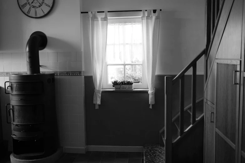 a kitchen with a table, a shelf and some windows