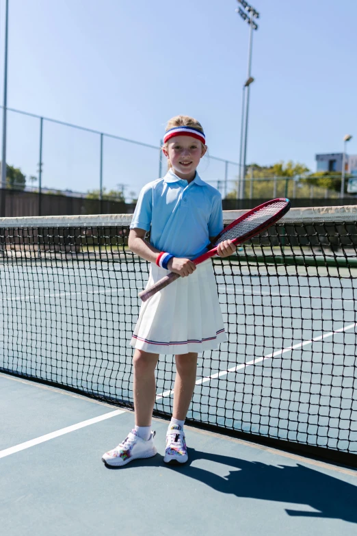 a  holding a tennis racket on a court