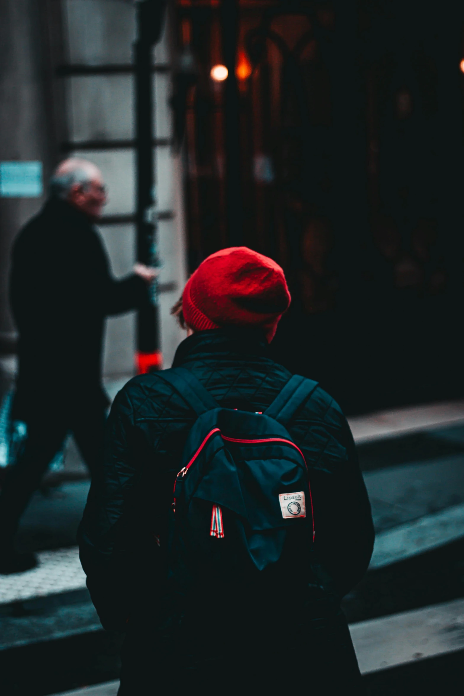 a man walking down the street in front of a building