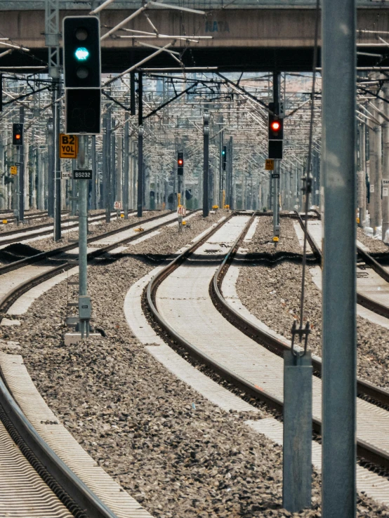 the signal lights show red and indicate green for railroad tracks