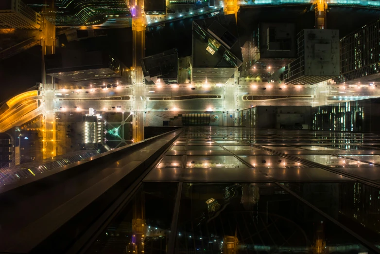 an illuminated city with many bridges above the street