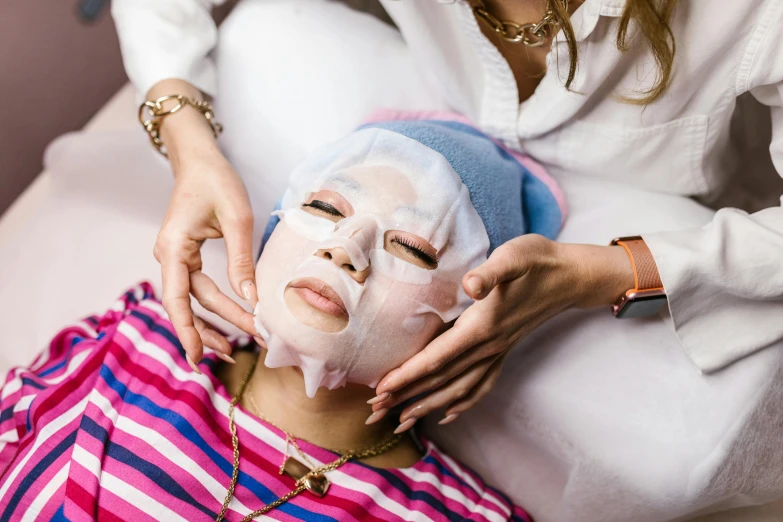 a woman using a mask on her face