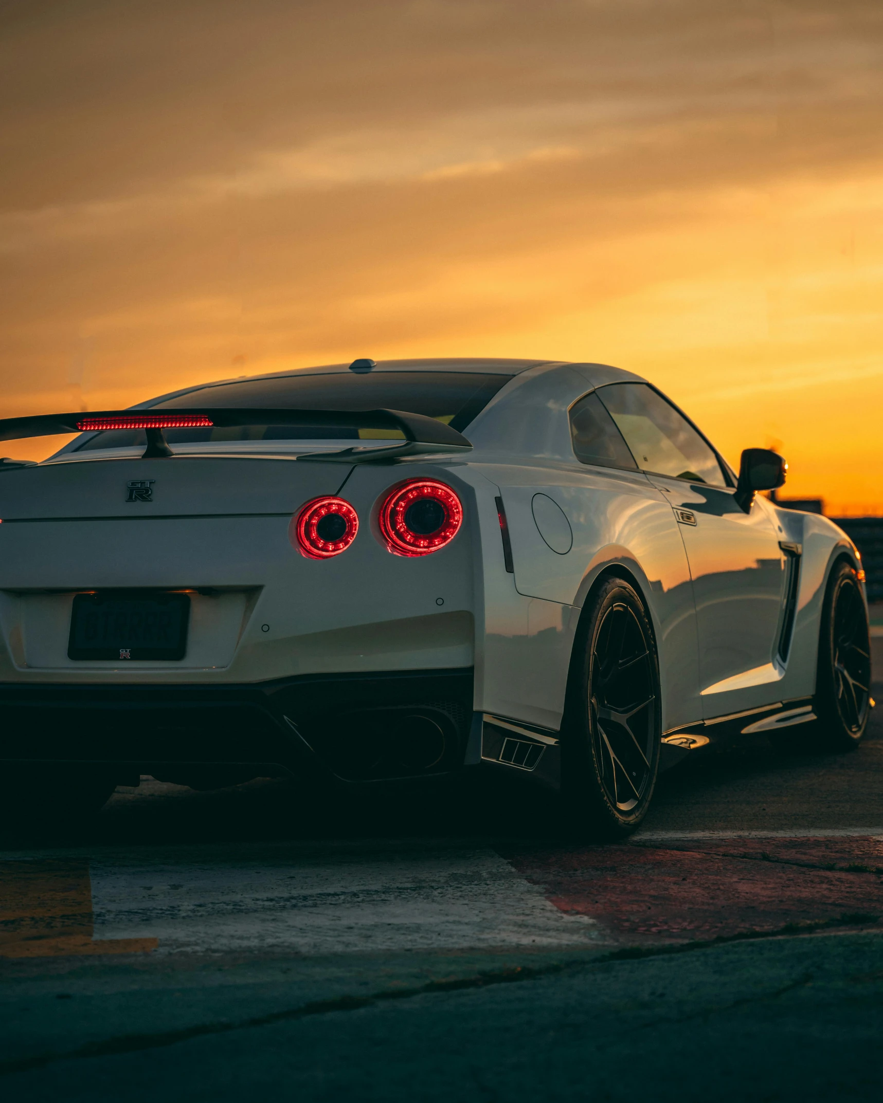 the rear end of a white sports car on display