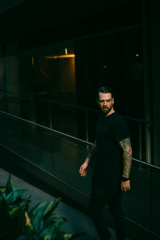 a man walking down a street in front of a window