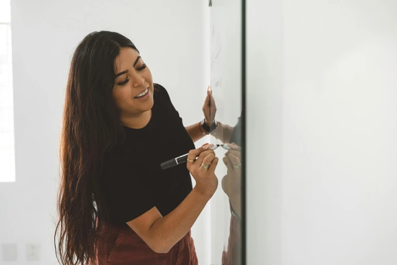a woman putting magnets on a door to use for soing