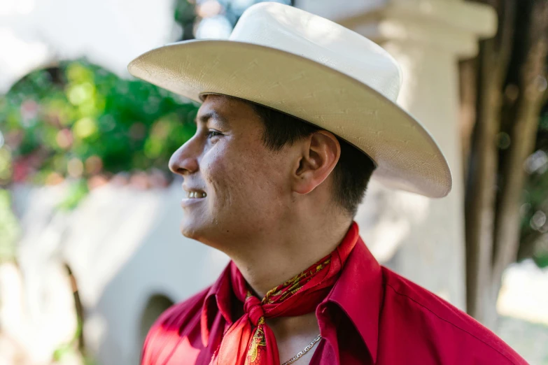 a close up of a person wearing a hat and a tie