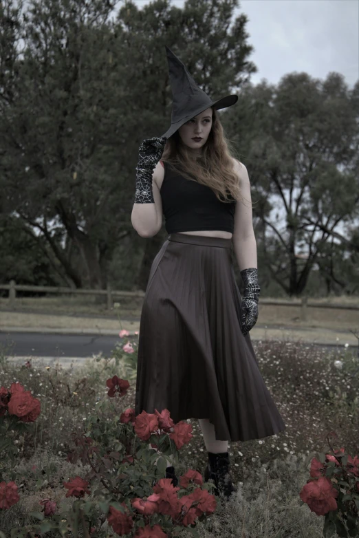 a woman wearing a witches costume with a hat