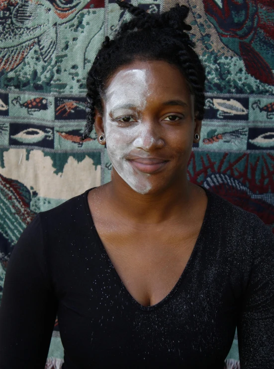 a woman with white paint on her face is smiling for a po