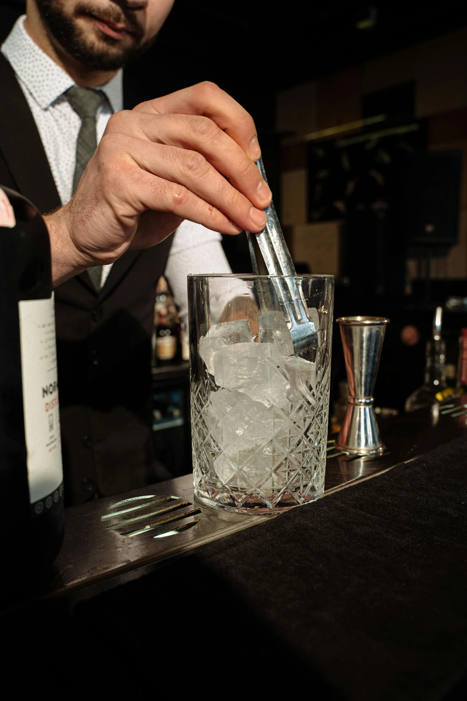 a man pours himself some drink on the bar