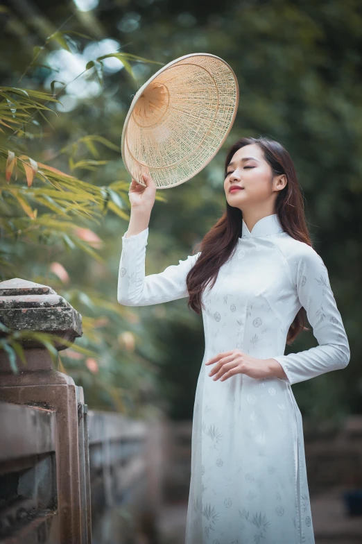 a woman holding up a mirror in front of her head