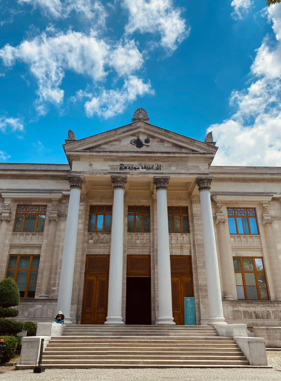 a large stone building with columns and windows