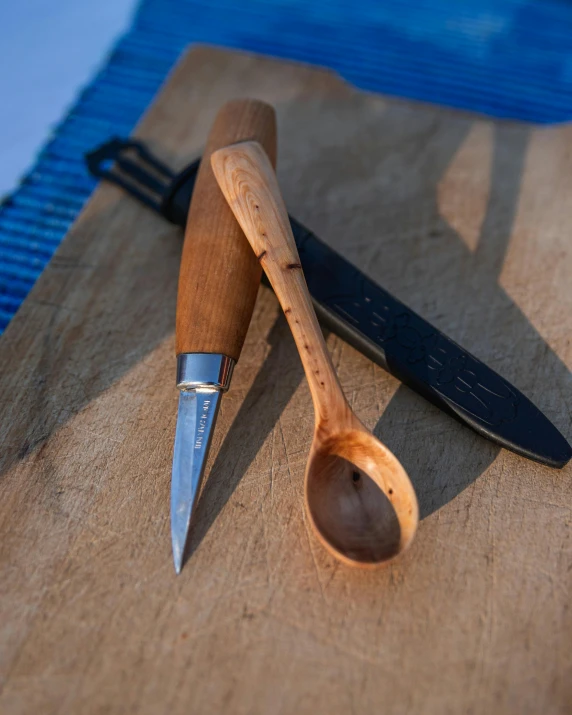 some kind of wooden spoon and knife on a table