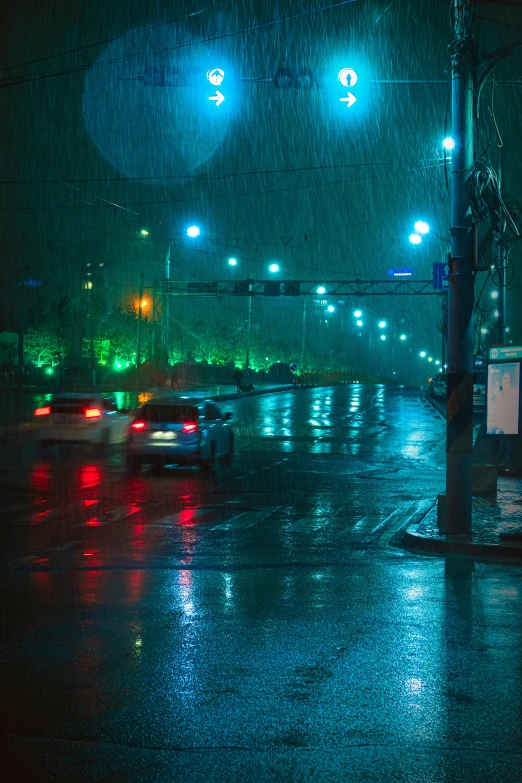 a car driving on a wet road with traffic lights