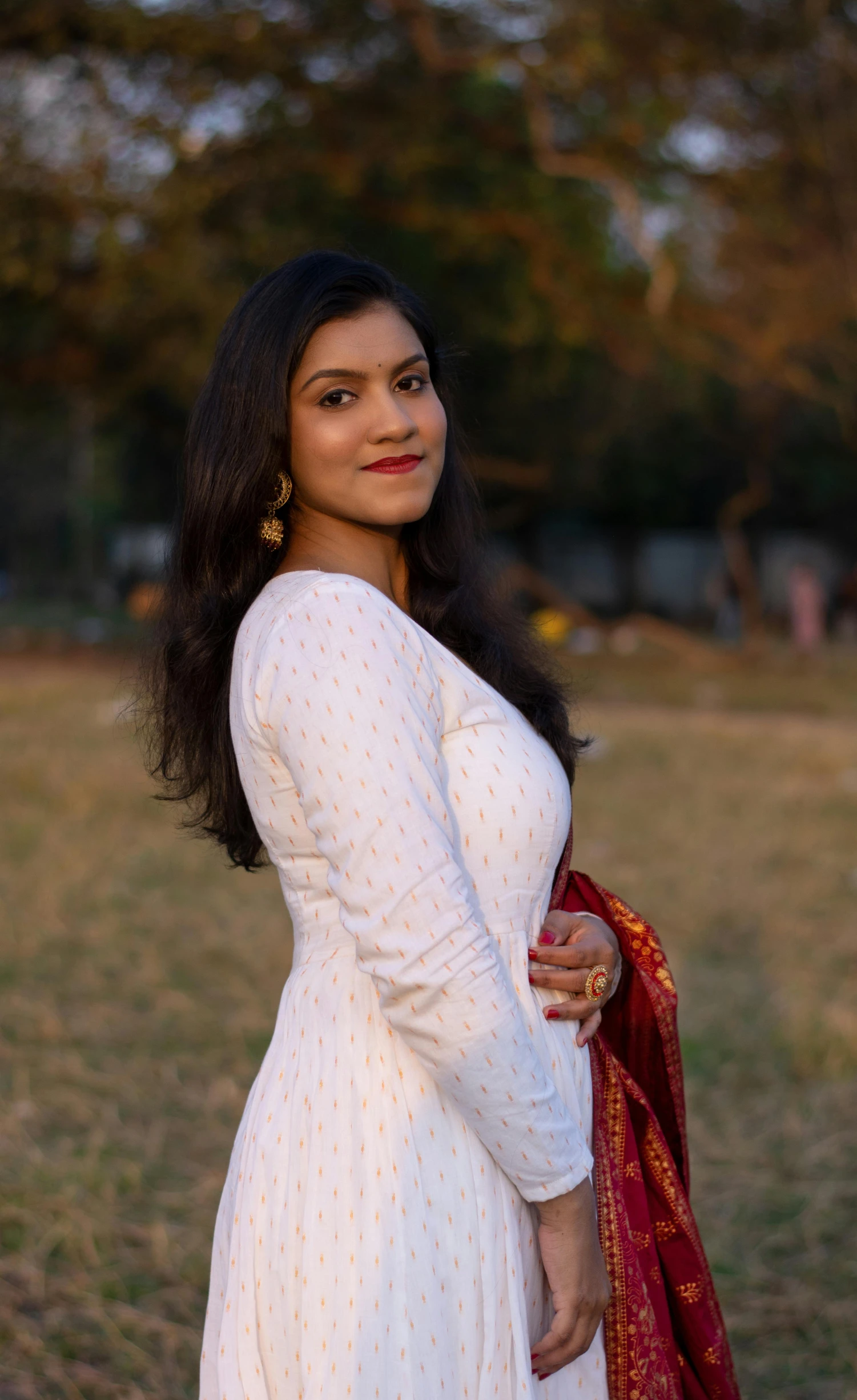 a woman in a white dress holding her shawl