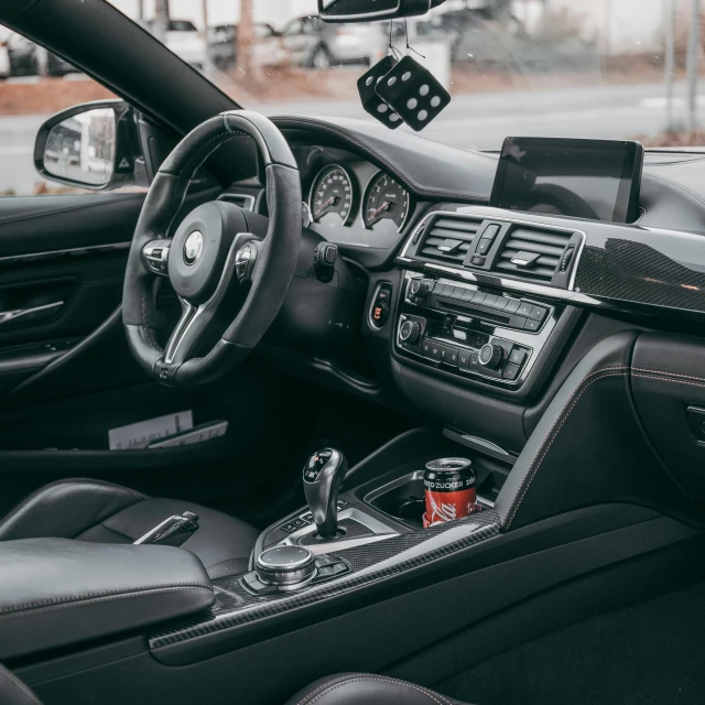 the interior of a bmw car showing its steering and dash controls