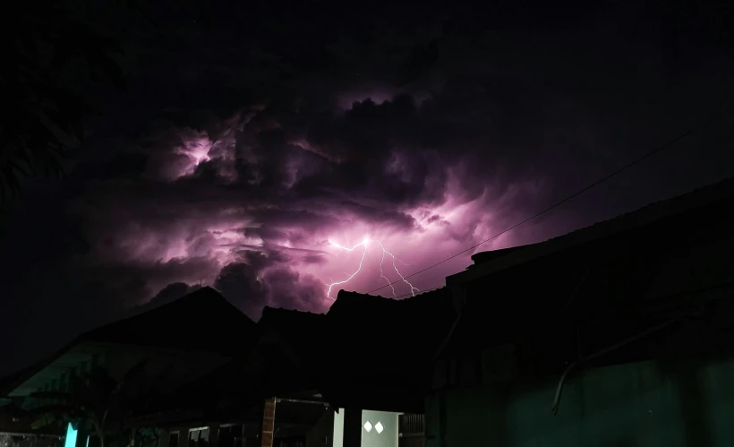 a night view of a dark sky with several lightning clouds