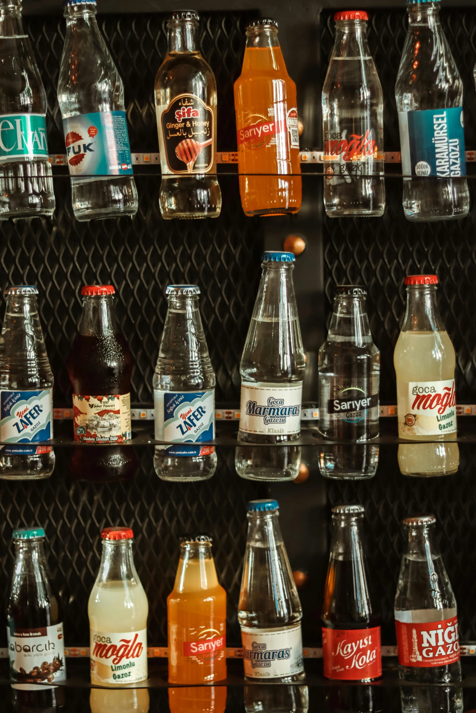 various bottled beverages are lined up against the wall