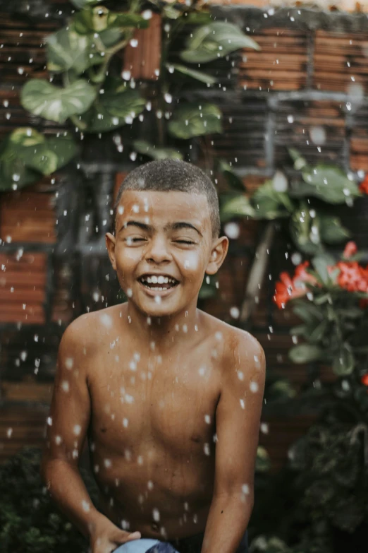 an image of a young child smiling in the rain