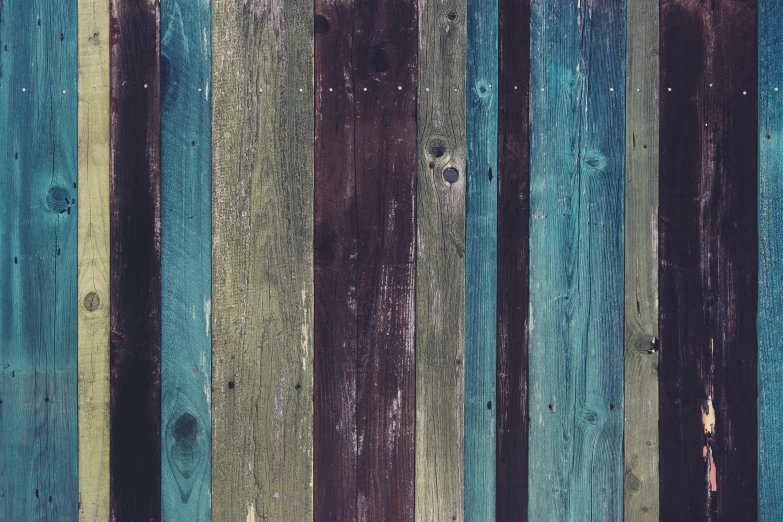 wood planks are painted a vint blue and green hue