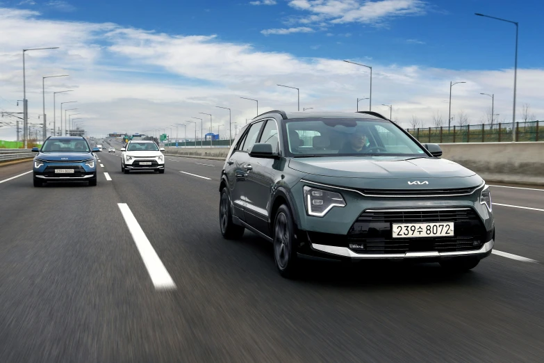 two suvs riding down the highway near each other