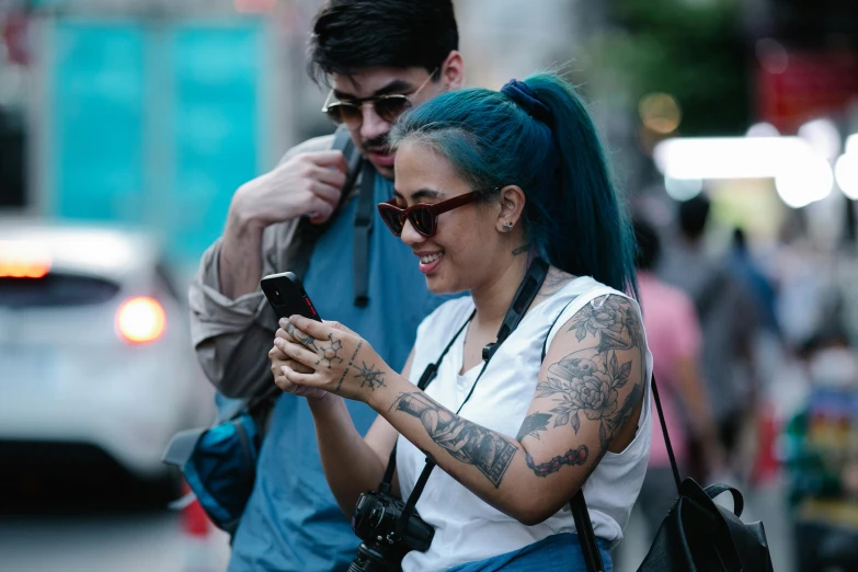 a person standing while texting on her phone