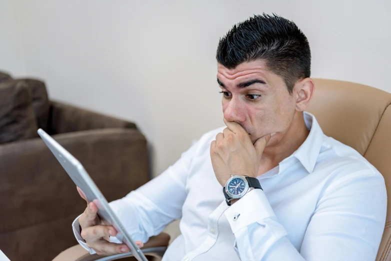 man with laptop looking unhappy about going on vacation