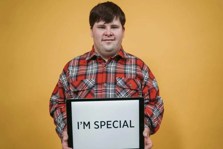 a man holding a sign with a word written in it