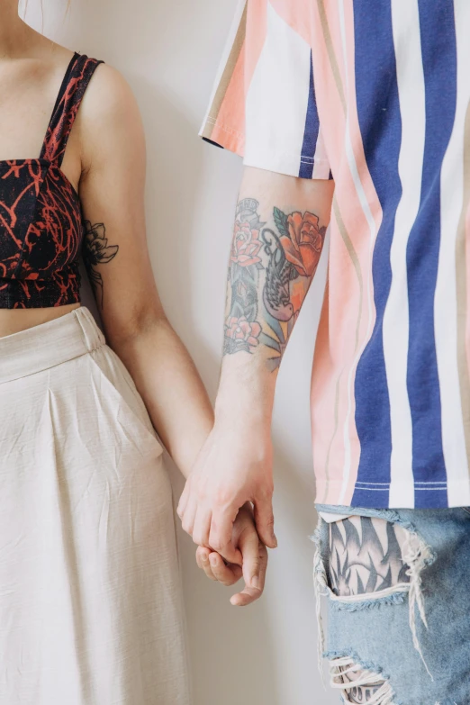 a couple holding hands while standing together