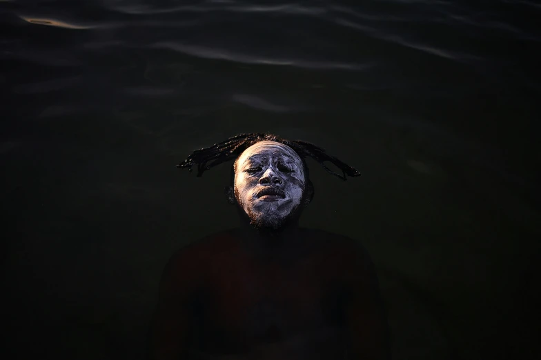 a man is seen in the water with white face