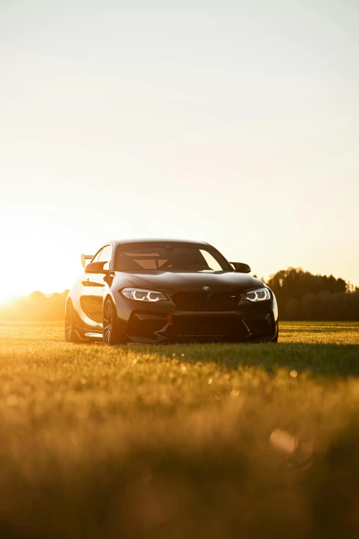 a car parked in a field near the sun