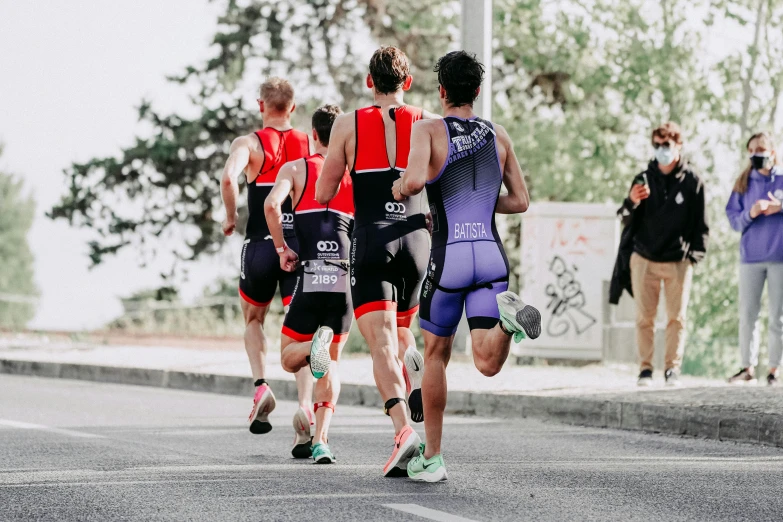 a group of runners crossing the road