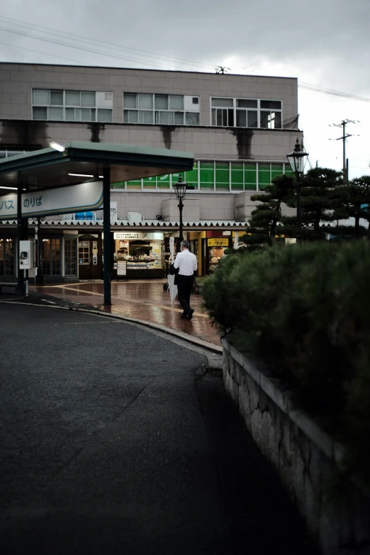 two people walking through a courtyard area to their business