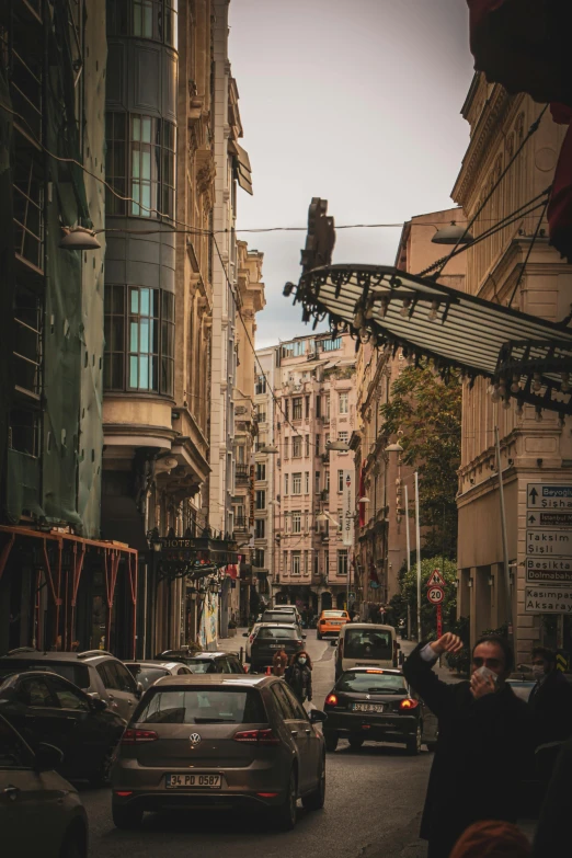 a street lined with lots of traffic driving through an old city