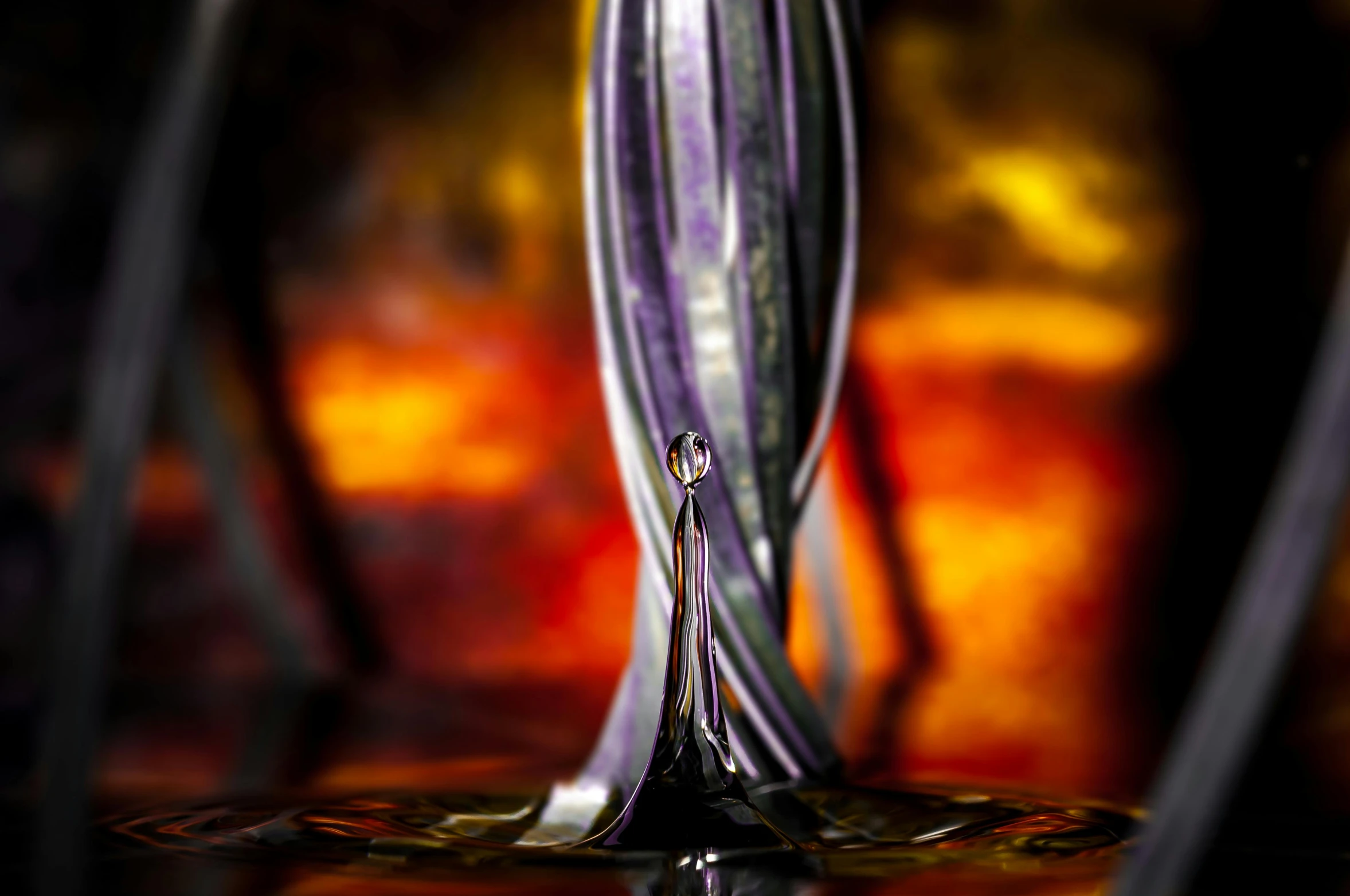 a closeup of a silver spoon on a liquid filled surface