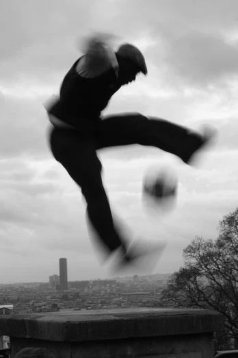 there is a man that is kicking a soccer ball
