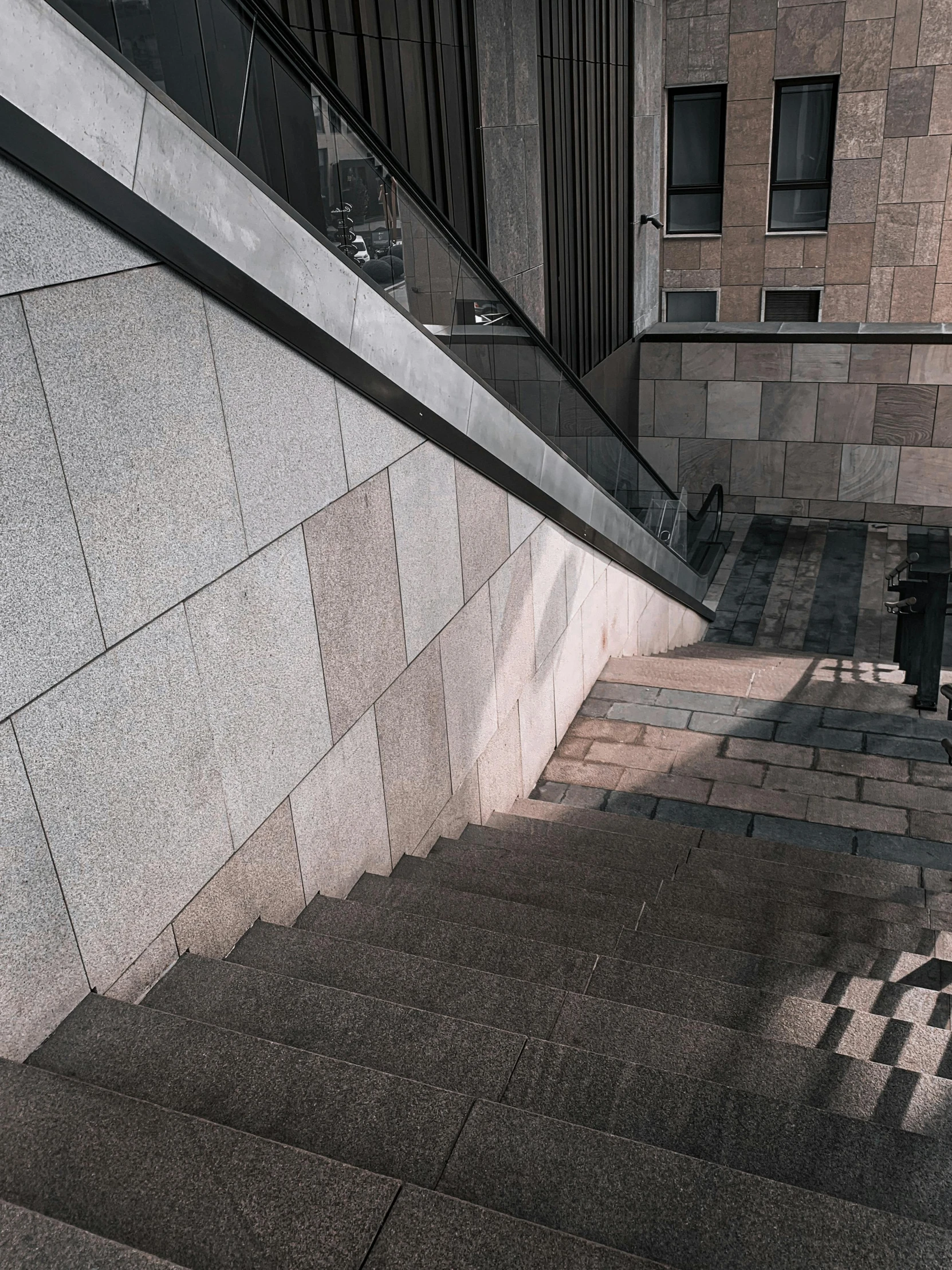 this is an empty street and a person is walking down the stairs