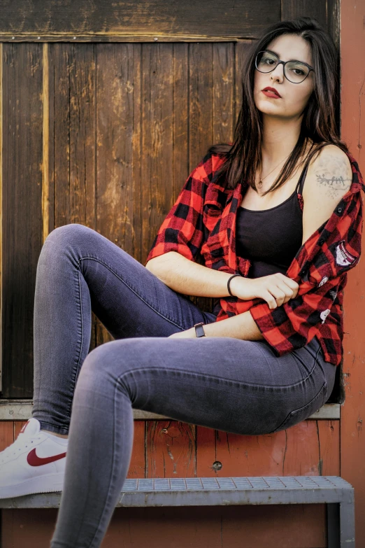 a beautiful young woman sitting on top of a wooden bench