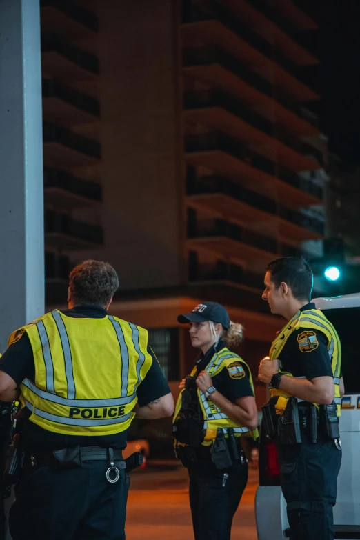 police officers stand on the sidewalk talking