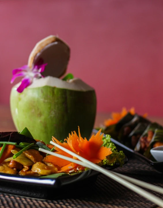 a green apple, carrots and broccoli is placed on a plate