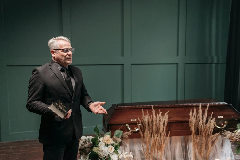 a man in a suit with one hand out for a presentation