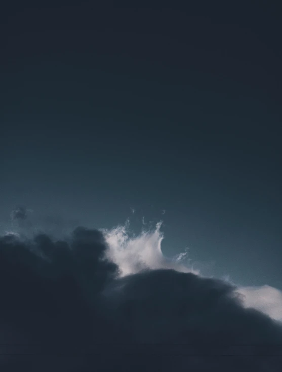 clouds in the dark sky with a plane in the middle