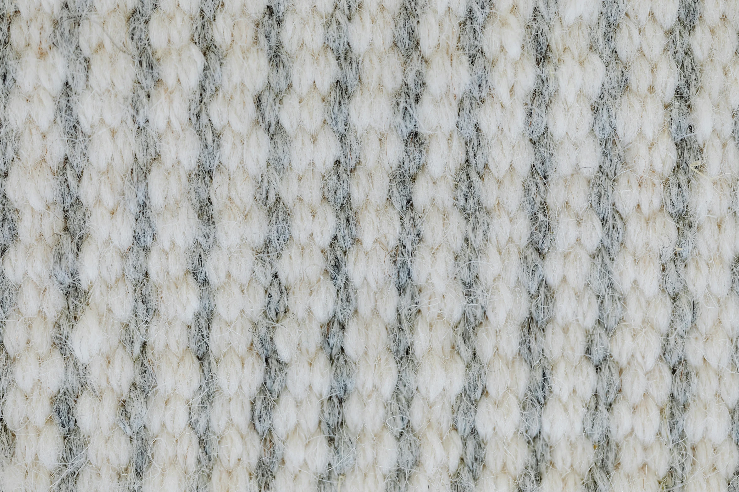 a carpeted surface with grey, black and white spots