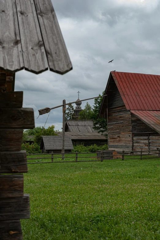 small cabin next to other structures with a red roof