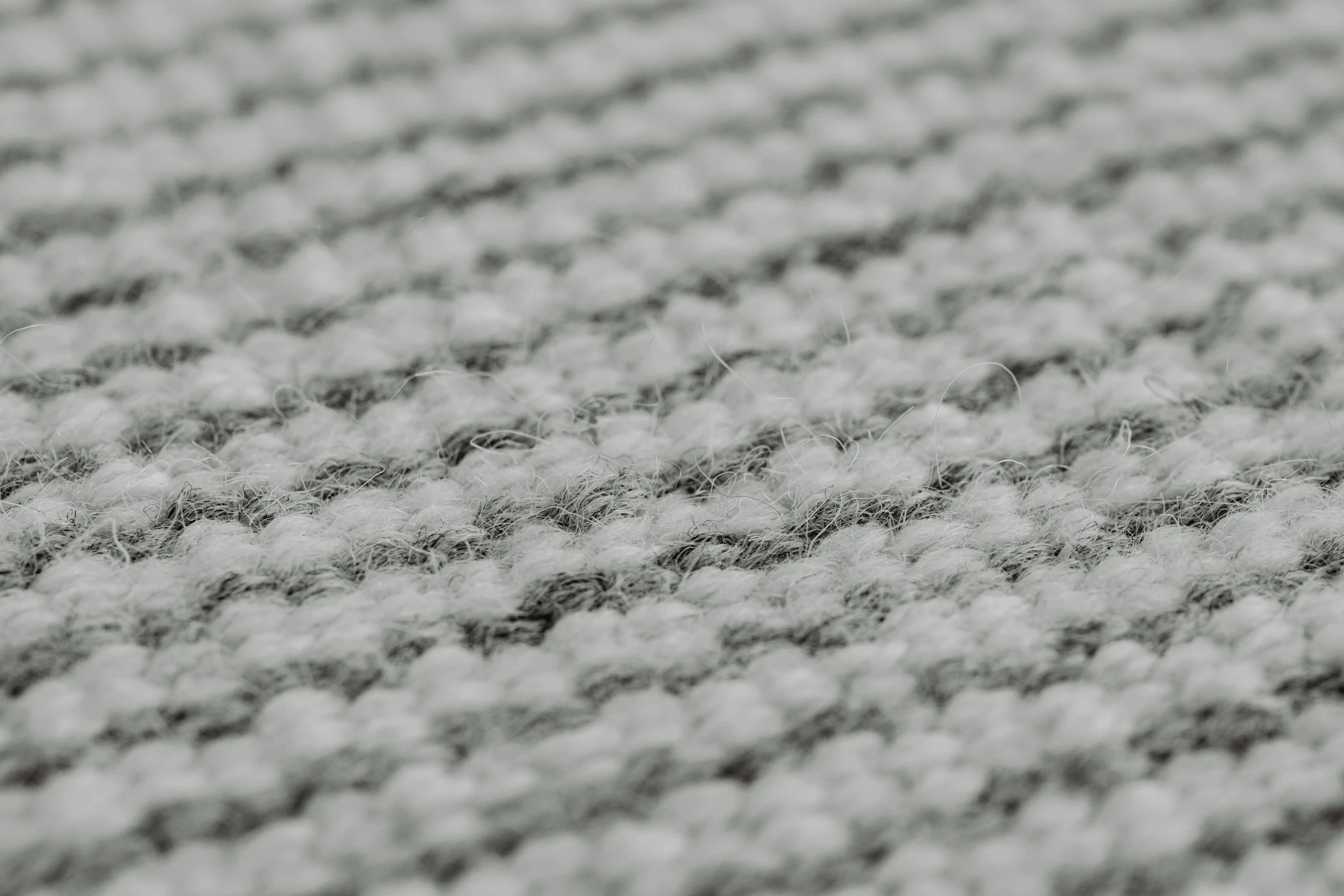 closeup of the side of a carpet with dark and light gray lines