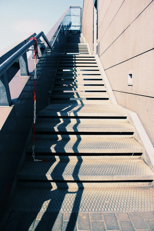 steps in front of concrete building with shadows on them