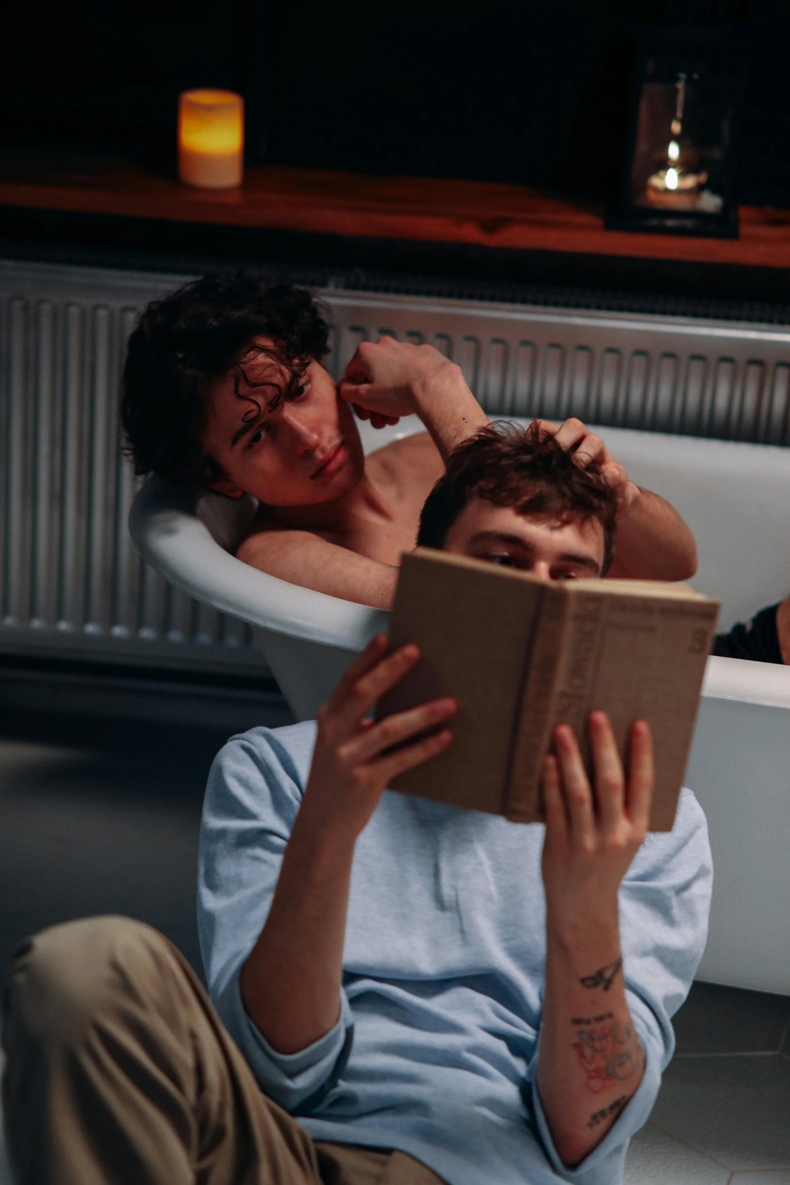 a couple laying down and reading a book