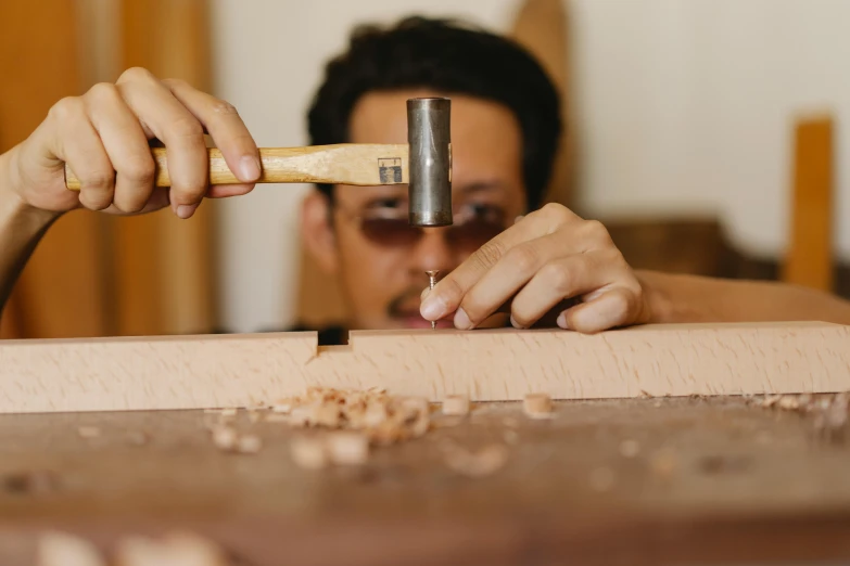 man working with woodworking with a circular plane