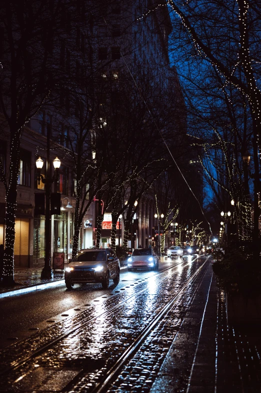 cars traveling on the street on a rainy night