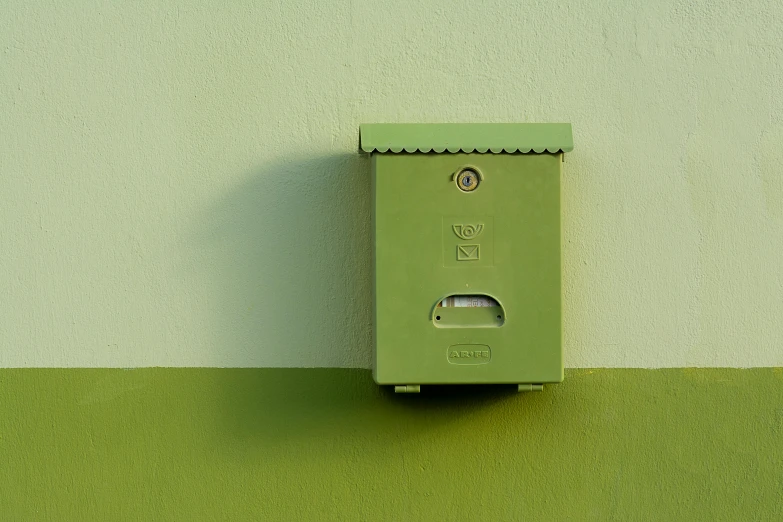 a green box with two holes for a bathroom